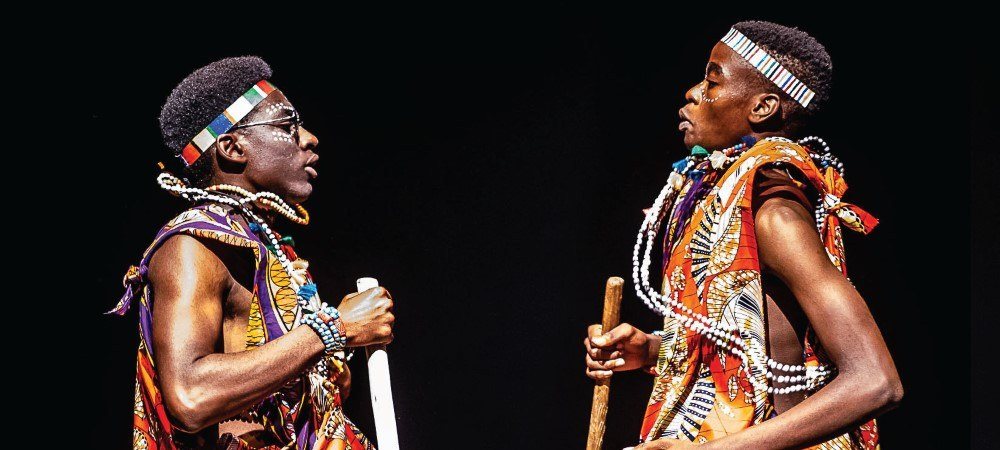 Two performers in traditional dress on stage